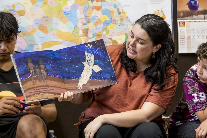 Teacher reading children's book to children